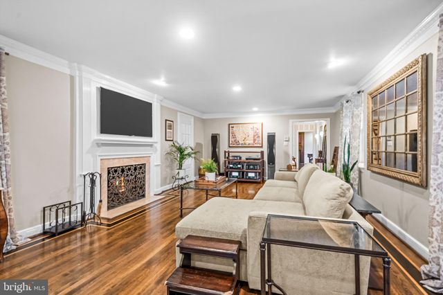 a living room with fireplace furniture and a flat screen tv