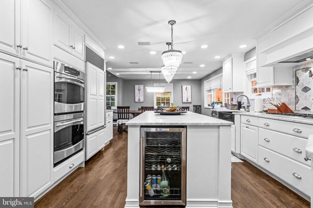 a kitchen with stainless steel appliances kitchen island granite countertop a stove and a refrigerator