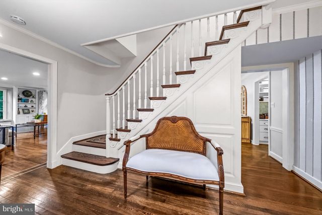 a living room with wooden floor and furniture