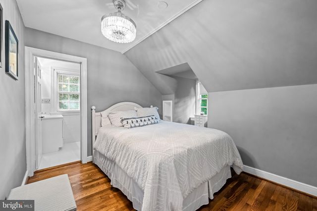 a kitchen with white cabinets and window