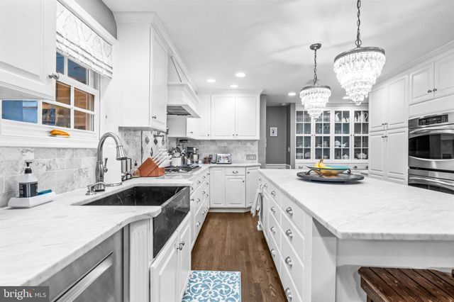 a kitchen with cabinets a sink and appliances