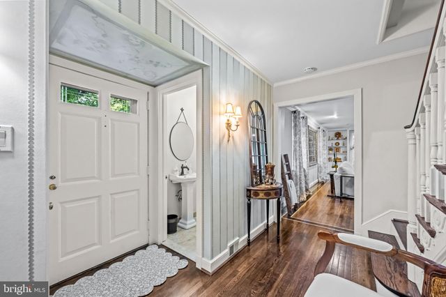 a view of a hallway with wooden floor and entryway
