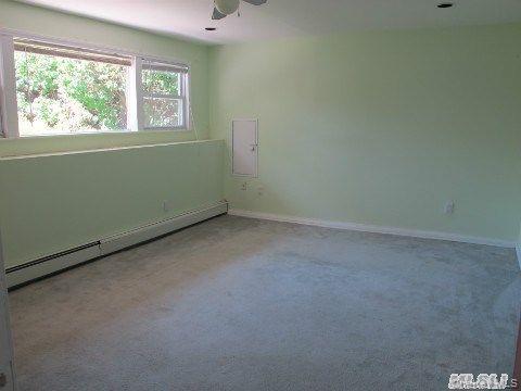 5 Elm Street Great Neck, NY 11021 - Photo 10 of 17 an empty room with a window