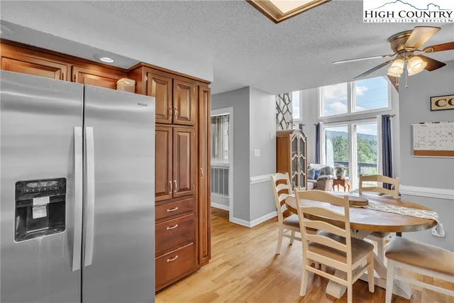 a dining table chair next to a window