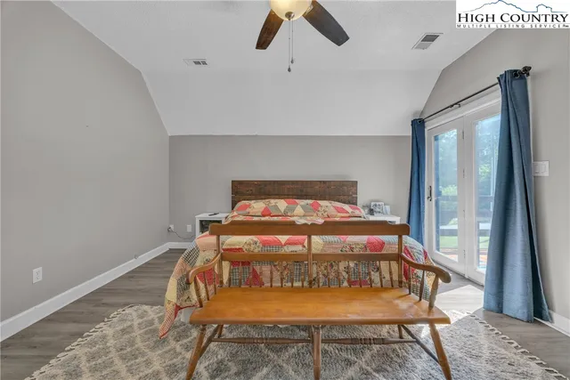 a bed sitting in a bedroom next to a window