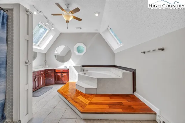 a view of staircase with a fireplace and a chandelier