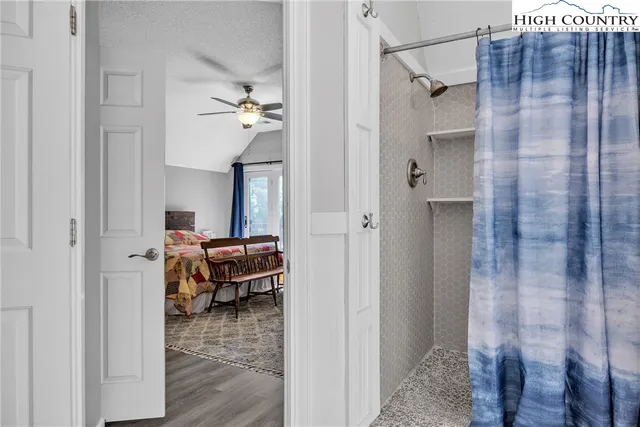 a bedroom with a bed and a view of bathroom