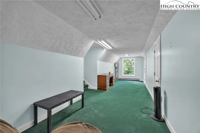 a bedroom with furniture and a flat screen tv