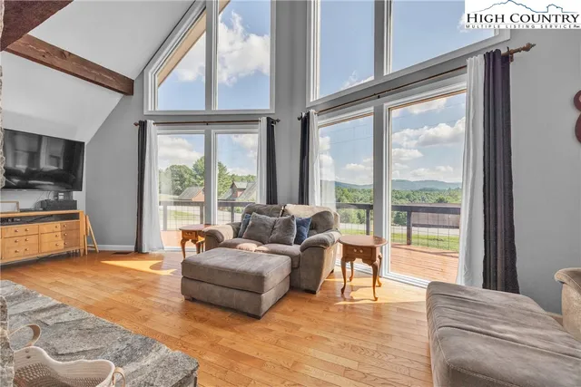 a living room with furniture and large windows