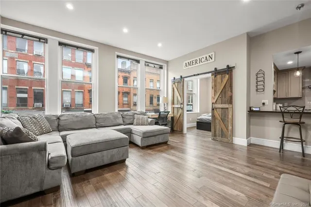 a living room with furniture and a large window