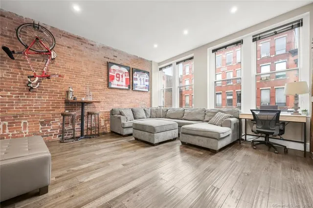 a living room with furniture and a wooden floor