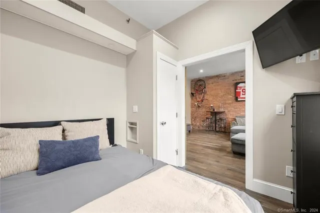 a bedroom with a bed and a flat screen tv