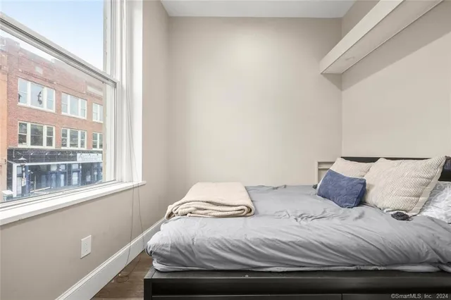 a bedroom with a bed and a window