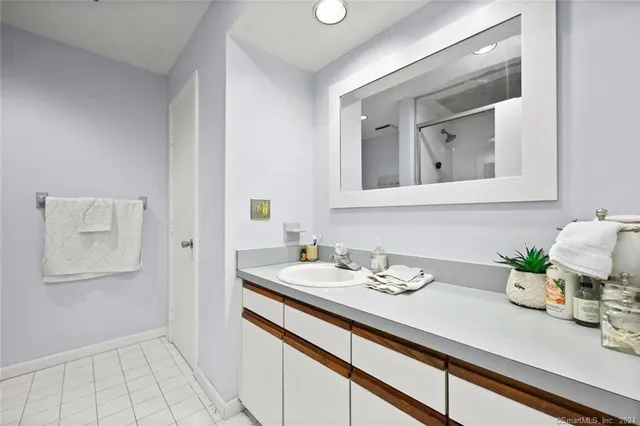 a bathroom with a sink a mirror and vanity