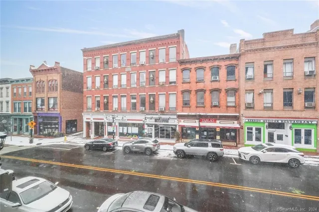 a view of a building with car parked