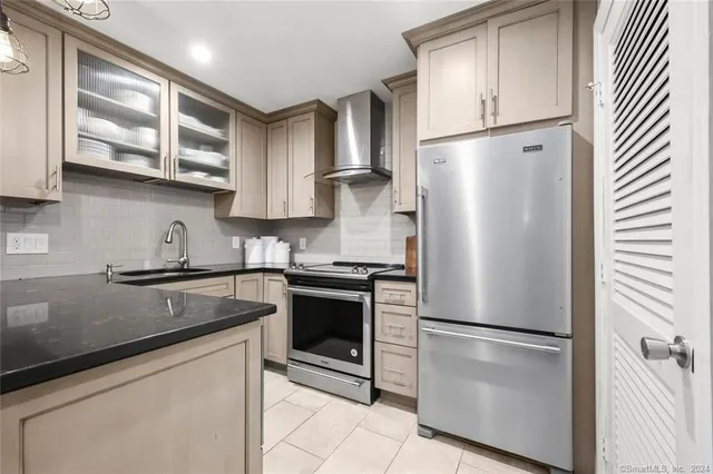a kitchen with stainless steel appliances granite countertop a refrigerator sink and cabinets