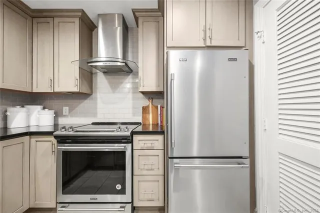 a kitchen with cabinets and stainless steel appliances