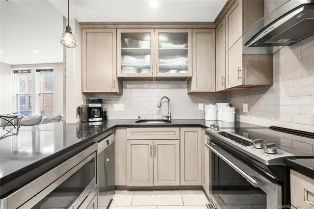 a kitchen with a sink stove and cabinets