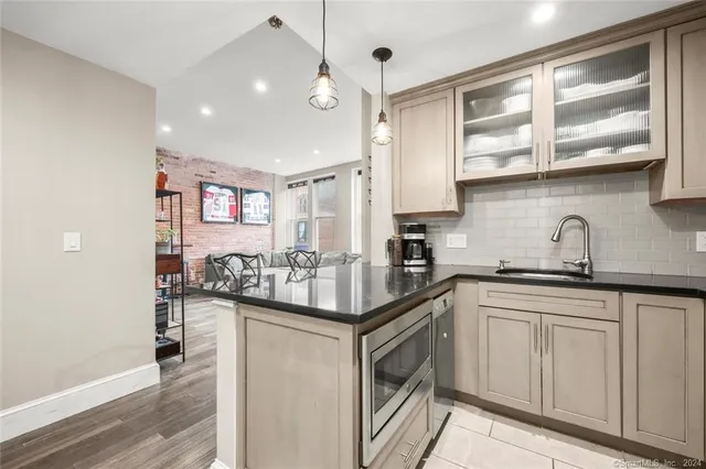 a kitchen with granite countertop a sink and cabinets