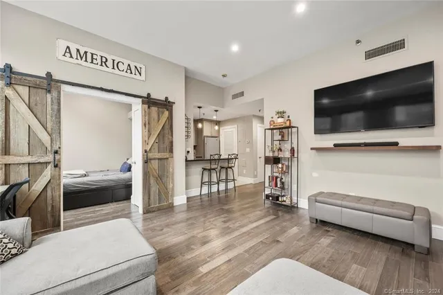 a view of living room kitchen with furniture and flat screen tv