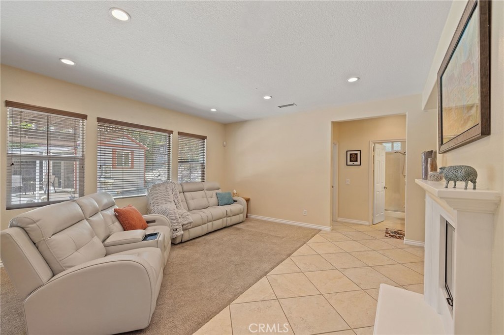 1729 Isabella Way Upland, CA 91784 - Photo 13 of 43 a living room with furniture a flat screen tv and a large window