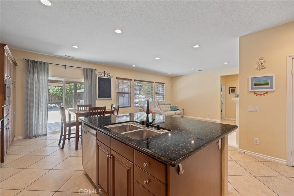 1729 Isabella Way Upland, CA 91784 - Photo 21 of 43 a kitchen with stainless steel appliances granite countertop a sink and a refrigerator
