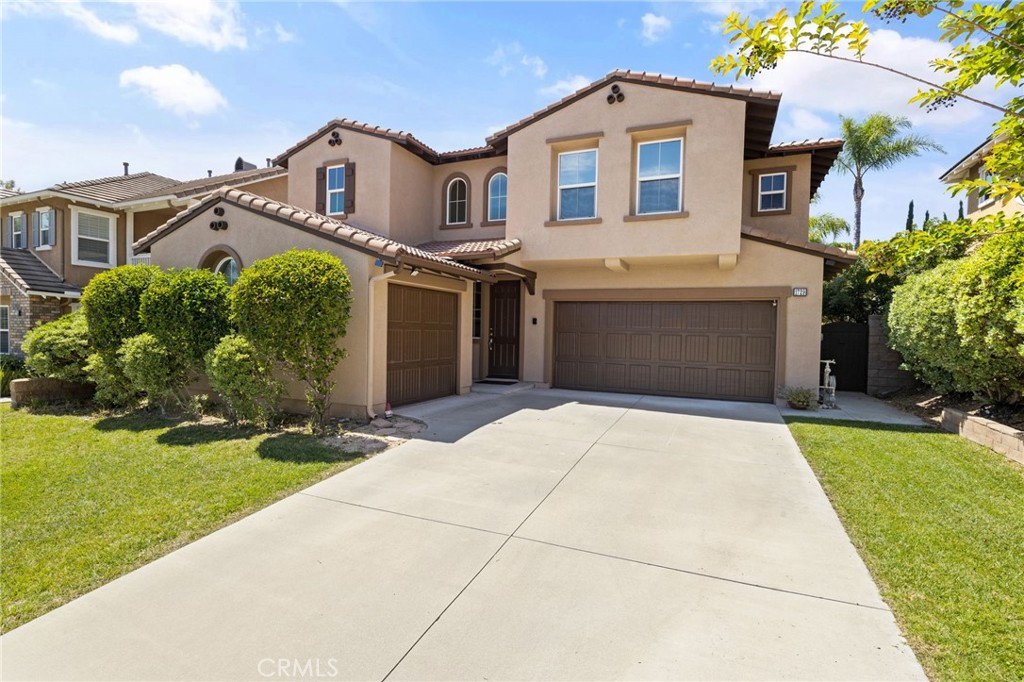 1729 Isabella Way Upland, CA 91784 - Photo 8 of 43 a front view of a house with a yard and garage