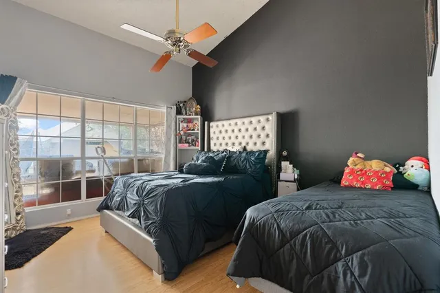 a bedroom with two beds and a large window