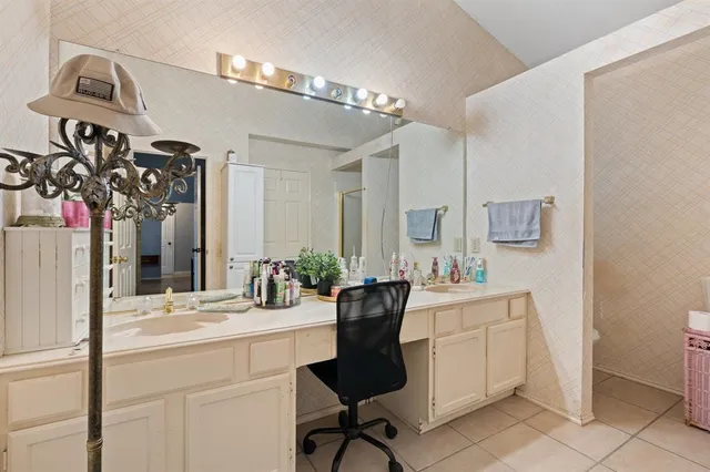 a bathroom with a sink a mirror and a chandelier