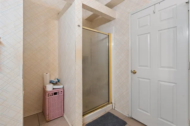 a bedroom with a bed chair and a large window