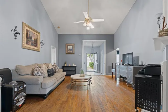 a living room with furniture and wooden floor