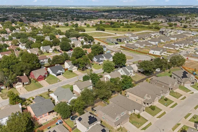 an aerial view of residential houses with outdoor space