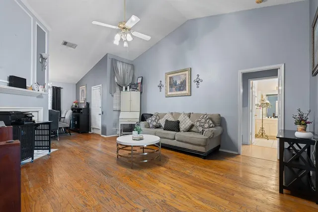 a living room with furniture and wooden floor
