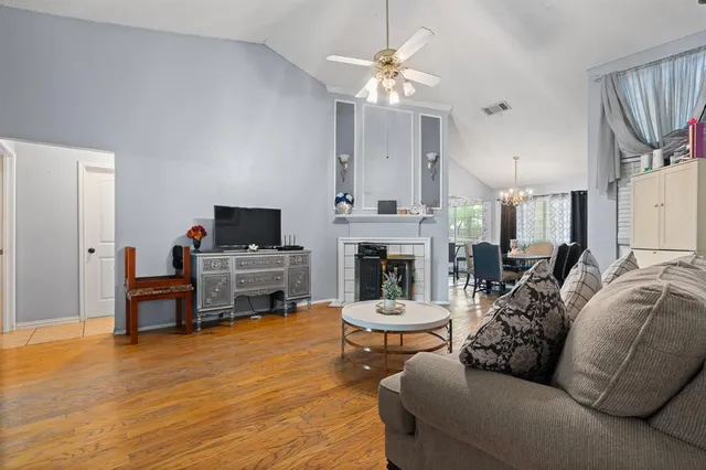 a living room with furniture a fireplace and a flat screen tv