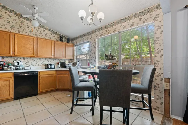 a kitchen with a dining table chairs and granite counter tops