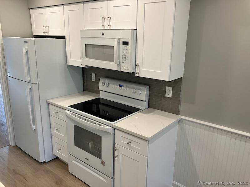 115 Fillow Street, Unit 61 Norwalk, CT 06850 - Photo 3 of 11 a kitchen with white cabinets and white appliances