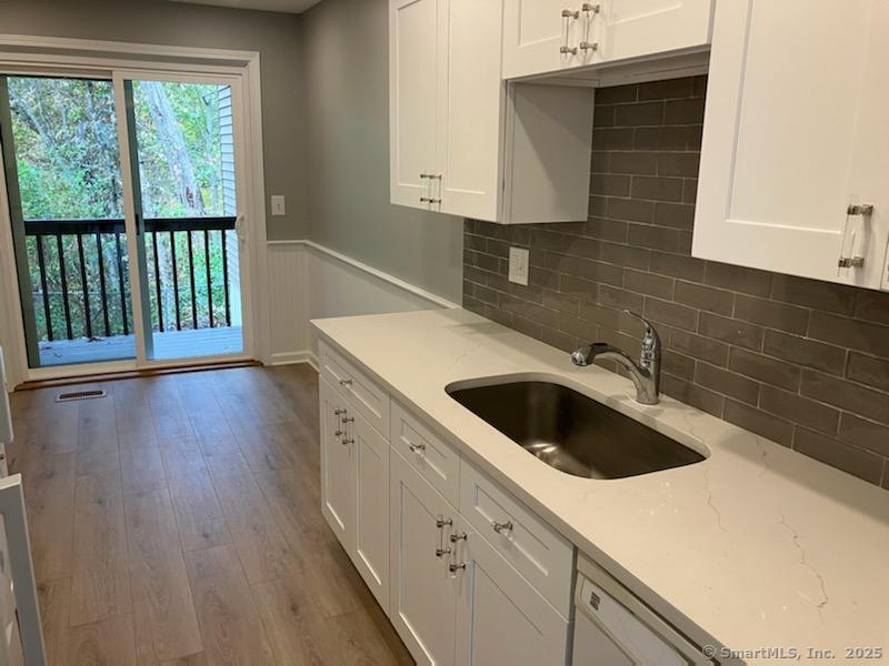 115 Fillow Street, Unit 61 Norwalk, CT 06850 - Photo 4 of 11 a kitchen with a sink and a window