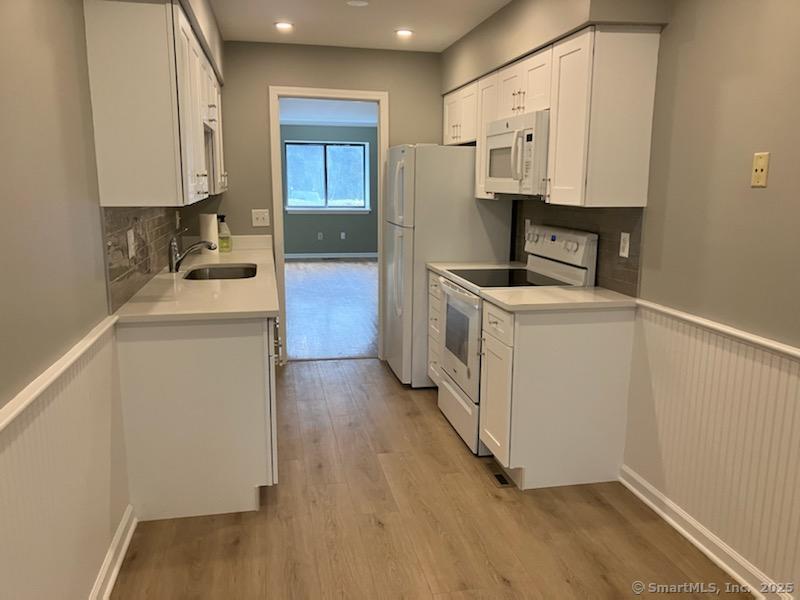 115 Fillow Street, Unit 61 Norwalk, CT 06850 - Photo 5 of 11 a kitchen with stainless steel appliances a stove a sink and a refrigerator