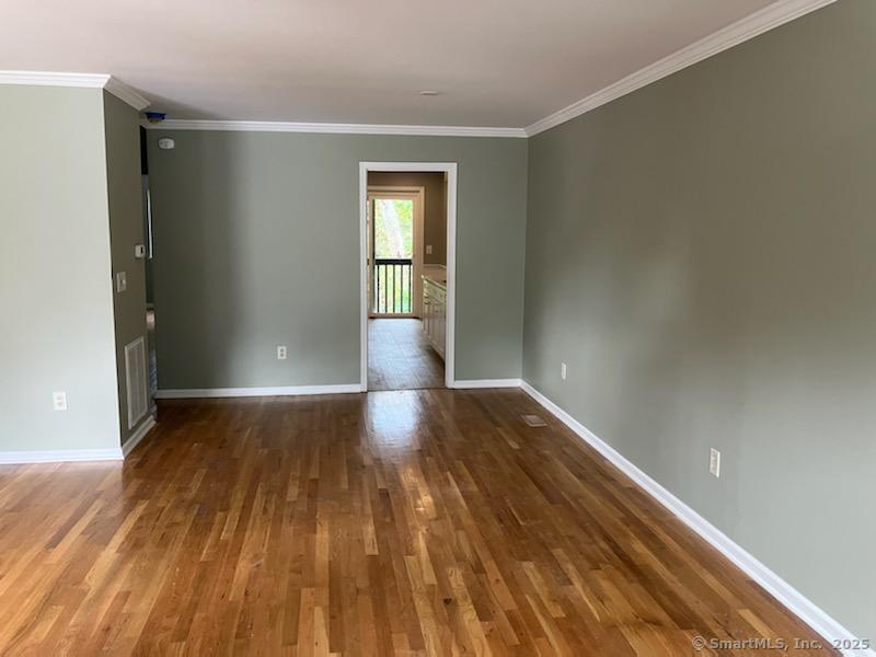 115 Fillow Street, Unit 61 Norwalk, CT 06850 - Photo 8 of 11 wooden floor in an empty room with a window