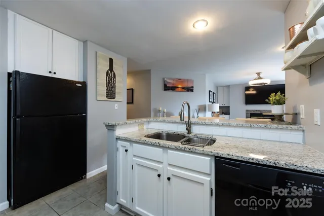 a kitchen with stainless steel appliances granite countertop a sink and dishwasher a stove top oven with wooden floor