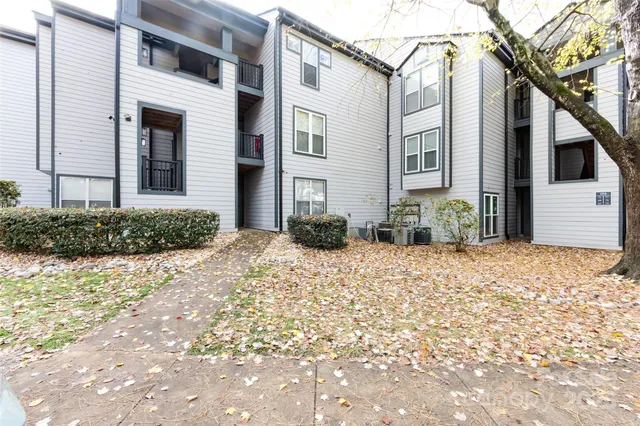 a view of a patio with table and chairs with wooden floor and fence