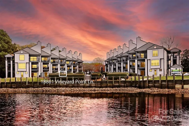 a front view of a building with lake view and boat
