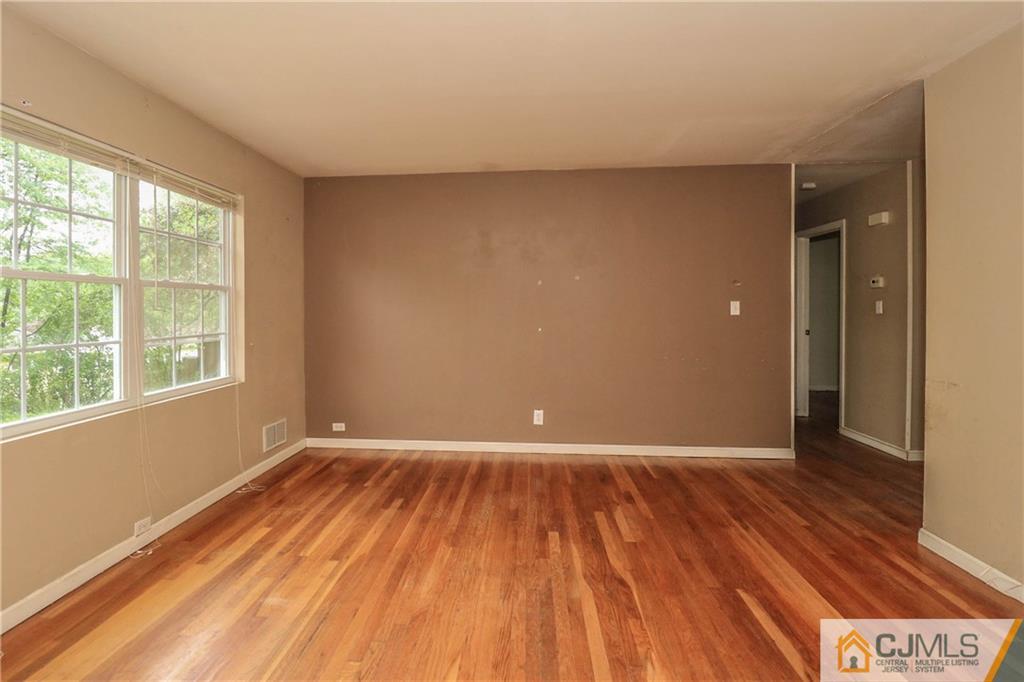 14 Fordham Road Old Bridge, NJ 08859 - Photo 13 of 22 a view of an empty room with wooden floor and a window