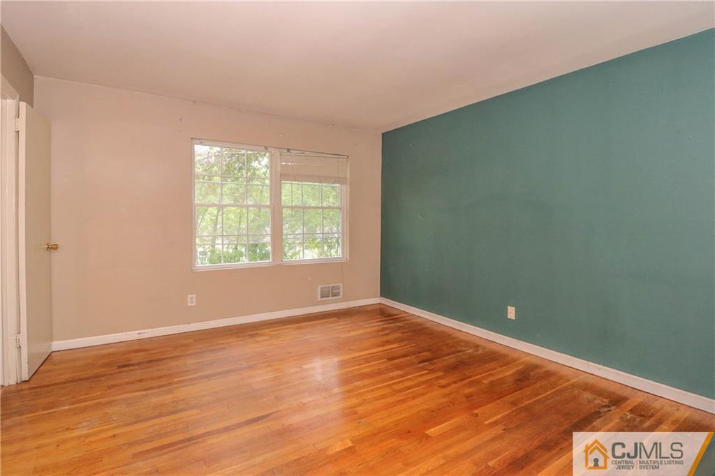 14 Fordham Road Old Bridge, NJ 08859 - Photo 14 of 22 an empty room with wooden floor and windows