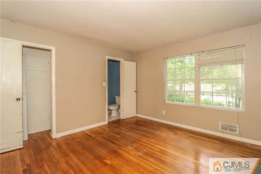 14 Fordham Road Old Bridge, NJ 08859 - Photo 15 of 22 a view of an empty room with wooden floor and a window