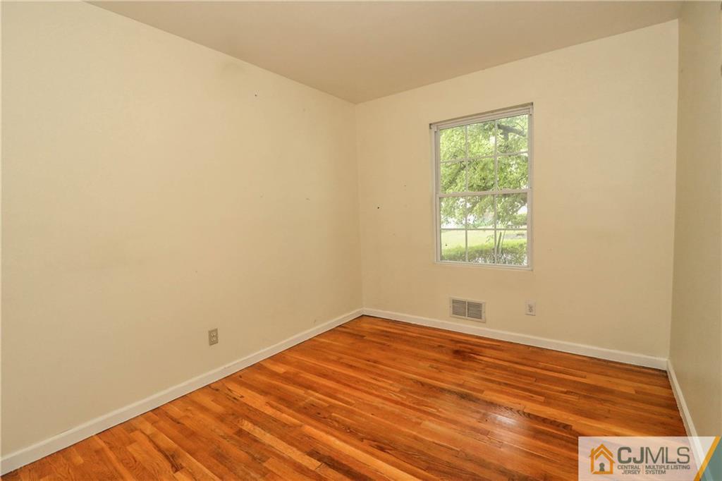 14 Fordham Road Old Bridge, NJ 08859 - Photo 19 of 22 an empty room with wooden floor and windows