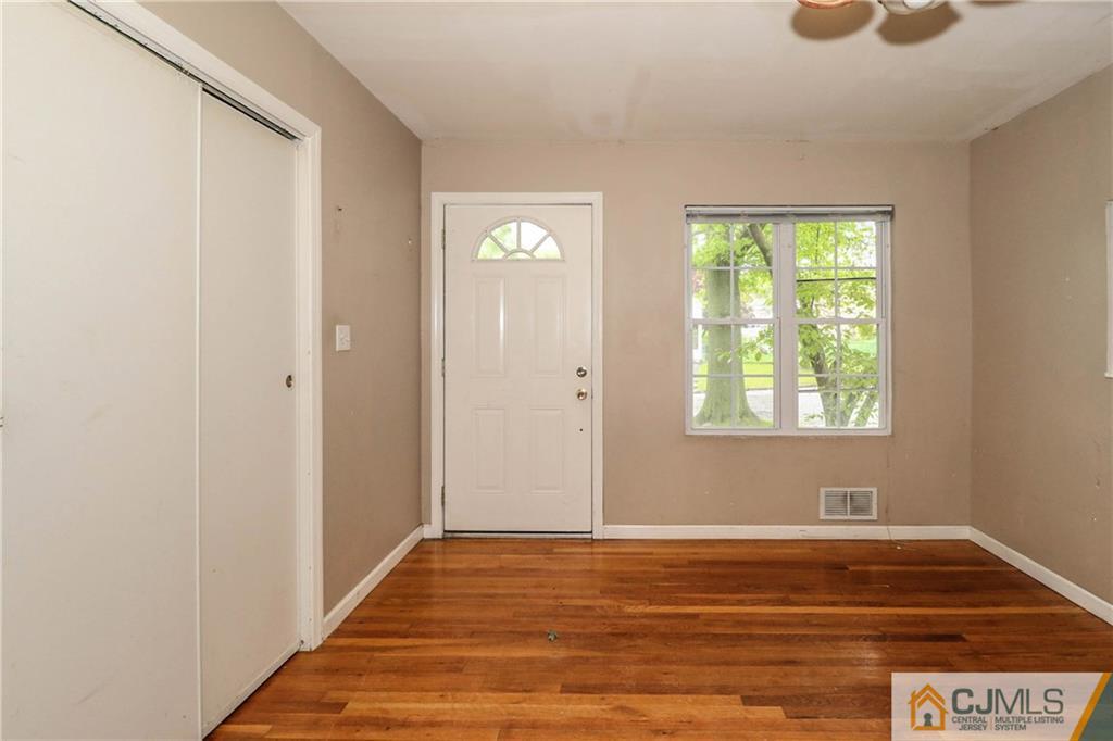 14 Fordham Road Old Bridge, NJ 08859 - Photo 7 of 22 a view of an empty room with wooden floor and a window