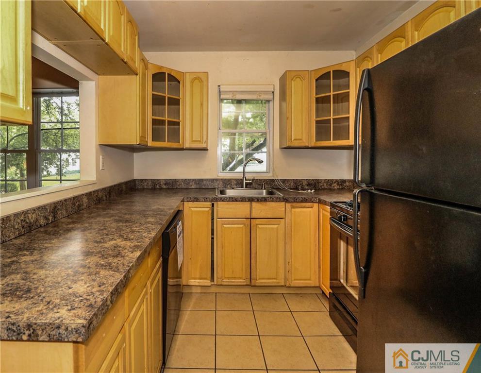 14 Fordham Road Old Bridge, NJ 08859 - Photo 9 of 22 a kitchen with a sink a refrigerator and cabinets