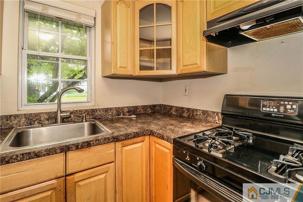 14 Fordham Road Old Bridge, NJ 08859 - Photo 10 of 22 a kitchen with granite countertop a stove and a sink
