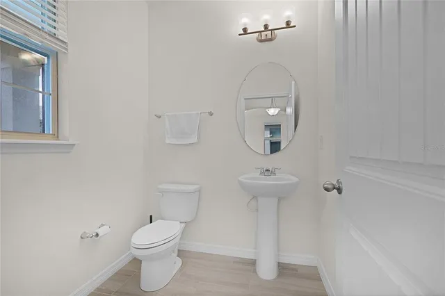 a view of a kitchen with a sink and chandelier